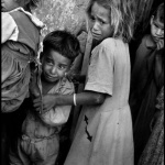 <p><b>Burt Glinn</b>, <i>SRAEL. El Arish. 1956. On the 3rd day of the war, frightened Arab children watch Israeli troops move through their town to the Suez Canal during the Sinai campaign.</i></p>