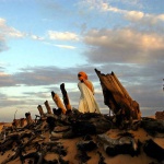 <p><b>Lynsey Addario</b>, 2004. NORTH DARFUR.  A Sudanese Liberation Army soldier walks through the remains of Hangala village, which was burned by Janjaweed near Farawiya, in Darfur, several months ago, August 27, 2004.  Thousands of ethnic Africans have fled their villages in search of shelter in the mountains or in neighboring Chad because of continuing attacks on civilians. </p>