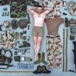 <p><b>Neil Leifer</b>, <i>Portrait of US Army Sergeant Duane Clemons surrounded by all of his battle gear during a photo shoot. Dhahran, Saudi Arabia 2/24/1991.</i></p>