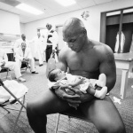 <p><b>Neil Leifer</b>, <i>Mike Tyson cradles his 2-month-old son Miguel in his arms after losing the 2002 WBC/ IBF/ IBO Heavyweight Title fight to Lennox Lewis at the Pyramid Arena. Memphis, Tennessee 6/8/2002.</i></p>