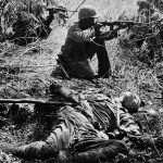 <p><b>W. Eugene Smith</b>, <i>US Marine rifleman taking aim near body of dead Japanese soldier (killed in a banzai suicide charge) during the Battle of Saipan Island. World War II. Pacific Campaign. July 1, 1944.</p>