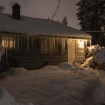 Icicles hanging from roof eaves at night