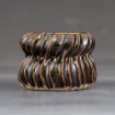 Pot with curving ridges by Aubrey Ganse