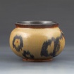 Brown and black pot by Hannah Wiggins