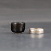 Very small black teabowl (ring for size comparison) by Leo Woods